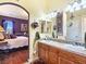 Ensuite bathroom features dual sinks, vanity, arched doorway and stylish decor at 1830 E Fuchsia St, Pahrump, NV 89048