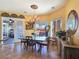 Bright dining area boasts a chandelier, table, and a view of the backyard patio at 1830 E Fuchsia St, Pahrump, NV 89048