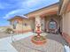 Charming desert home with a tiered water fountain, custom exterior lighting, and cozy seating area at 1830 E Fuchsia St, Pahrump, NV 89048
