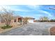 Desert home with a terracotta roof, well-manicured shrubs and circular driveway at 1830 E Fuchsia St, Pahrump, NV 89048