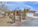 Charming desert home with a water fountain, palm trees, and landscaped front yard at 1830 E Fuchsia St, Pahrump, NV 89048