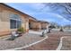 Desert home with a front yard featuring a decorative bench, water fountain, and well-kept shrubbery at 1830 E Fuchsia St, Pahrump, NV 89048