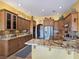The kitchen features custom cabinets, stainless steel appliances, and granite countertops at 1830 E Fuchsia St, Pahrump, NV 89048