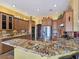 Spacious kitchen boasts custom cabinets, stainless steel appliances, and granite countertops at 1830 E Fuchsia St, Pahrump, NV 89048