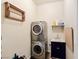 Efficient laundry area features stacked washer/dryer and convenient utility sink and drying rack at 1830 E Fuchsia St, Pahrump, NV 89048