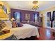 Elegant bedroom with hardwood floors, chandelier, and ornate furnishings exudes sophistication at 1830 E Fuchsia St, Pahrump, NV 89048