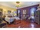 Elegant bedroom with hardwood floors, chandelier, and ornate furnishings exudes sophistication at 1830 E Fuchsia St, Pahrump, NV 89048