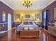 Elegant bedroom with hardwood floors, chandelier, and ornate furnishings exudes sophistication at 1830 E Fuchsia St, Pahrump, NV 89048