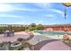 Beautiful backyard pool with waterfall feature, dining area, and mountain views at 1830 E Fuchsia St, Pahrump, NV 89048