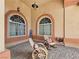 Quaint porch featuring wheel-inspired rocking chairs, decorative pillows, and welcoming ambiance at 1830 E Fuchsia St, Pahrump, NV 89048