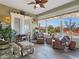 Bright sunroom with floral decor, ceiling fan, and views of the backyard pool at 1830 E Fuchsia St, Pahrump, NV 89048