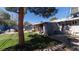 This is a grassy backyard with a patio, shady trees, and privacy fence at 1908 Hassett Ave, Las Vegas, NV 89104
