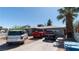 Home exterior featuring a well-maintained front yard with three cars in the driveway and a lovely palm tree at 1908 Hassett Ave, Las Vegas, NV 89104