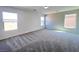 Spacious bedroom features gray carpet, natural light from multiple windows at 2316 Cockatoo Dr, North Las Vegas, NV 89084