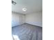 Bedroom features gray carpet, neutral paint, and two white interior doors at 2316 Cockatoo Dr, North Las Vegas, NV 89084