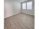 Cozy bedroom with wood-look flooring and bright, natural light at 2316 Cockatoo Dr, North Las Vegas, NV 89084