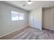 Bedroom features gray carpet, natural light from a window, and closet at 2316 Cockatoo Dr, North Las Vegas, NV 89084