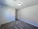 Bedroom features gray carpet, interior door, and double sliding-door closet at 2316 Cockatoo Dr, North Las Vegas, NV 89084