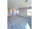 Large bedroom with neutral paint, carpet, and natural light from windows at 2316 Cockatoo Dr, North Las Vegas, NV 89084