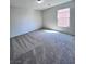 Bedroom with gray carpet, natural light from window, and neutral color paint at 2316 Cockatoo Dr, North Las Vegas, NV 89084