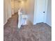 Upstairs hallway has neutral carpeting and doors leading to bedrooms and bathrooms at 2316 Cockatoo Dr, North Las Vegas, NV 89084