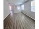 Open-concept living room featuring wood-look floors and natural light at 2316 Cockatoo Dr, North Las Vegas, NV 89084