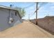 Side view of building featuring a secure fenced gravel lot that offers privacy and ample parking space at 2424 Statz St, North Las Vegas, NV 89030
