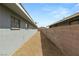 Narrow outdoor gravel lot with block and board fences, perfect for low-maintenance landscaping at 2424 Statz St, North Las Vegas, NV 89030