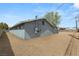 Exterior view of gray building with gravel and fence, creating a secure and low-maintenance outdoor space at 2424 Statz St, North Las Vegas, NV 89030