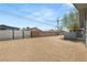 Exterior gravel yard surrounded by fences, offering a private and low-maintenance space at 2424 Statz St, North Las Vegas, NV 89030