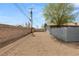 Gravel lot featuring block fences, which allows for secure outdoor space and easy maintenance at 2424 Statz St, North Las Vegas, NV 89030