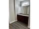 A vanity area offers a granite counter, cabinets, large mirror, and a modern light fixture above the mirror at 2451 N Rainbow Blvd # 1156, Las Vegas, NV 89108