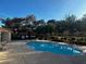 A shared pool for the residents of this complex offers lounge chairs and well-manicured foliage at 2451 N Rainbow Blvd # 1156, Las Vegas, NV 89108