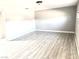 Spacious living room with new light gray paint, white trim and light wood laminate flooring at 2508 Alfa Cir, Las Vegas, NV 89142