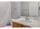Bathroom with a white sink, wood cabinet, and a large mirror at 2621 Adelante Ave # 104, Las Vegas, NV 89106