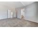 Bedroom with grey walls and carpeting leading to bathroom and hallway at 2621 Adelante Ave # 104, Las Vegas, NV 89106
