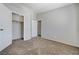 A bright, neutral bedroom with carpet, closet, and doorways that contribute to the overall appeal at 2621 Adelante Ave # 104, Las Vegas, NV 89106