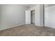 Neutral bedroom showcasing carpet, closets, and doors that increase the property's appeal at 2621 Adelante Ave # 104, Las Vegas, NV 89106