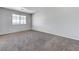 Spacious bedroom with a large window and neutral carpet at 2621 Adelante Ave # 104, Las Vegas, NV 89106
