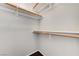 Walk-in closet with built-in wooden shelving and plush carpeting at 2621 Adelante Ave # 104, Las Vegas, NV 89106