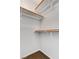 Walk-in closet with built-in wooden shelves and carpet at 2621 Adelante Ave # 104, Las Vegas, NV 89106