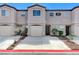 Charming townhome featuring a private garage and well-maintained front landscaping at 2621 Adelante Ave # 104, Las Vegas, NV 89106