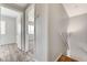 Upstairs hallway with wood floors and doors to carpeted rooms at 2621 Adelante Ave # 104, Las Vegas, NV 89106