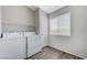 The laundry room features modern appliances, a window, shelves, and plenty of natural light at 2621 Adelante Ave # 104, Las Vegas, NV 89106