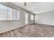 Open living area with hardwood flooring and abundant natural light from multiple windows at 2621 Adelante Ave # 104, Las Vegas, NV 89106