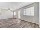 Inviting living room with wood flooring, a ceiling fan, and sliding doors leading to the backyard at 2621 Adelante Ave # 104, Las Vegas, NV 89106