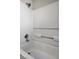 Close-up of shower with white surround and chrome fixtures at 2621 Adelante Ave # 104, Las Vegas, NV 89106