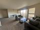 Spacious living room area featuring plush carpet and balcony access at 2845 Loveland Dr # 3616, Las Vegas, NV 89109