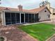 Relaxing backyard featuring a screened-in porch, small patch of artificial turf, and desert landscaping at 3316 Cutty Sark St, Las Vegas, NV 89117