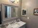 Bathroom with stylish sink and vanity with light grey paint and new hardware, framed mirror, and decor at 3316 Cutty Sark St, Las Vegas, NV 89117
